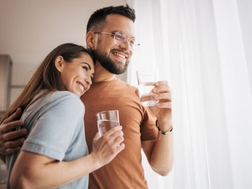 Young Warrenville couple enjoying a clean glass of water.
